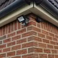 a close up of a brick building with a camera attached to it