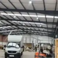 a warehouse filled with lots of different types of vehicles