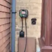 a phone is on the side of a building