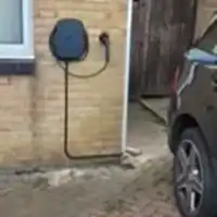 a car parked in front of a brick building