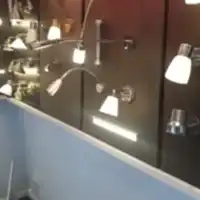 a bathroom with a lot of lights on the wall