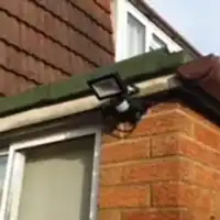 a man is fixing a gutter gutter gutter gutter gutter gut