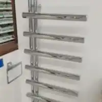 a bathroom with a towel rack next to a window